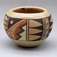 A small polychrome bowl decorated with a four-panel feather and geometric design
 by Juanita Fragua of Jemez