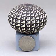 A miniature black-on-white seed pot decorated with a geometric design
 by Wanda Aragon of Acoma
