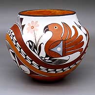A polychrome jar with a four-panel parrot, flower, rainbow and geometric design
 by Marie S Juanico of Acoma
