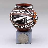 A miniature polychrome jar decorated with a four-panel geometric design
 by Lilly M Salvador of Acoma