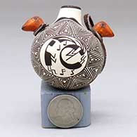 A miniature polychrome canteen with bird head handles and decorated with a kokopelli, medallion, fine line and geometric design
 by Wanda Aragon of Acoma