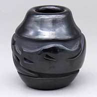 A small black jar with an avanyu design carved around the shoulder
 by Jennifer Naranjo of Santa Clara