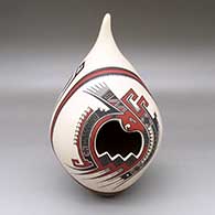 A polychrome tear-drop jar decorated with a geometric cutout and a lightly-carved-and-panted parrot, serpent and geometric design
 by Tavo Silveira of Mata Ortiz and Casas Grandes