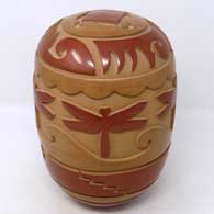 Red and brown seed pot carved with kiva step, dragonfly and geometric design