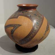 Carved, sgraffito and painted shard and geometric design on a brown jar