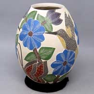 Polychrome jar with sgraffito and painted bird, butterfly, flower and branch design