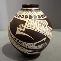 Free-flowing Paquime geometric design painted on a brown and white jar