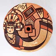 A polychrome mixed-clay seed pot decorated with a lightly-carved and painted Hopi dancer and geometric design