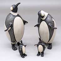 A polychrome family of four penguins decorated with a geometric design