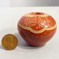 Sgraffito katsina and geometric design on a red seed pot