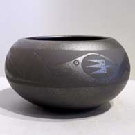 An avanyu design on a micaceous black jar by Johnny Cruz