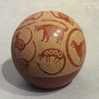 Sgraffito Mimbres animal designs on a red seed pot