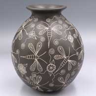 Black-on-white jar lightly carved and etched with a dragonfly and geometric design