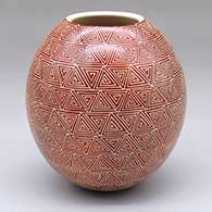 Sgraffito geometric design on a red and white jar