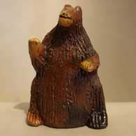 A brown ceramic bear figure