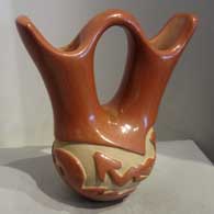 Mary Cain of Santa Clara Pueblo made this red wedding vase and carved it with an avanyu design