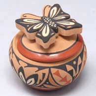 Jar with a geometric design and a butterfly handle