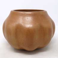 A formed, not carved, golden micaceous melon shaped jar