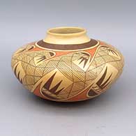 A polychrome jar decorated with a migration pattern geometric design and fire clouds
