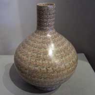 Geometric design on a tall-neck polychrome jar with a matching stand