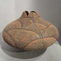 Textured polychrome jar with an organic opening