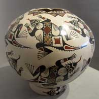 Stylized Mimbres horned toads, geometric design and a hexagonal opening on a brown jar
