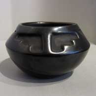 Geometric design carved into a black jar