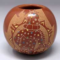 A polychrome seed pot with a sgraffito and painted mudhead dancer and geometric design
