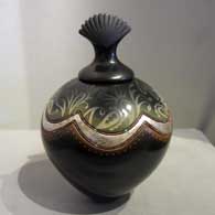 Etching, silver accent and heishi beads on a lidded, burnished jar, by Russell Sanchez