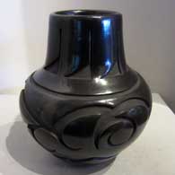 Black jar carved with avanyu design