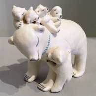 Five cubs on a bear storyteller figure