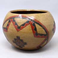A polychrome bowl decorated with a Navajo carpet design
