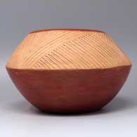 A red bowl with Potsuwi'i decorations carved and painted with micaceous clay above the shoulder