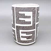 Black-on-white cylinder with a four-panel fine line geometric design
 by Carmel Lewis of Acoma