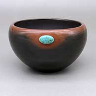 Black bowl with a sienna rim and an inlaid turquoise stone detail
 by Candace Tse Pe of San Ildefonso