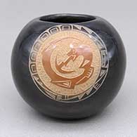 Miniature black seed pot with a sienna spot and a sgraffito avanyu and geometric design
 by Mae Tapia of Santa Clara