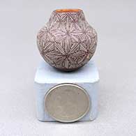 Miniature polychrome jar with a fine line geometric design
 by Delores Aragon Juanico of Acoma