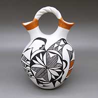 Polychrome wedding vase with a braided handle and a painted abstracted bird, fine line, and geometric design
 by Eva Histia of Acoma