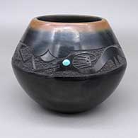 Black jar with a sienna rim, a sgraffito avanyu and raincloud geometric design, and an inlaid turquoise stone detail
 by TsePe of San Ildefonso