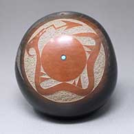 A black seed pot with a sienna spot and a sgraffito avanyu and geometric design with an inlaid stone
 by Juan Tafoya of San Ildefonso