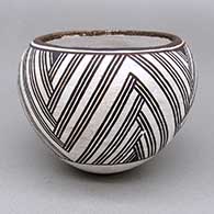 Small black-on-white bowl with a fine line geometric design
 by Lucy Lewis of Acoma