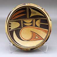 Click for a larger view A shallow polychrome bowl decorated with a stylized bird-hanging-from-sky-band, bird element and geometric design inside, and a two-panel geometric design around the outside
 by Unknown of Hopi