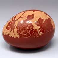 Red egg-shaped seed pot with a sgraffito rabbit, butterfly, flower and geometric design
 by Brenda Tafoya of Jemez