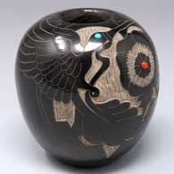 Black seed pot with a sgraffito hummingbird, flower and geometric design plus 2 inlaid stones
 by Unknown of Santa Clara