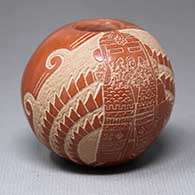 A miniature red seed pot decorated with a sgraffito kachina figure with feathers and a geometric design
 by Roy Tanner of Santa Clara
