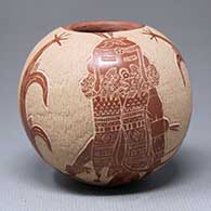 A red seed pot decorated with a sgraffito kachina figure with two corn plants and a geometric design
 by Roy Tanner of Santa Clara