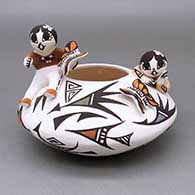 Polychrome jar with an applique and painted child, butterfly, and geometric design
 by Aggie Henderson of Acoma