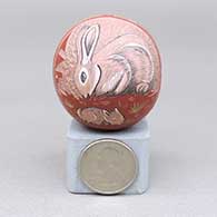 Miniature polychrome seed pot with a sgraffito and intricately painted rabbit and kit, desert plant, feather ring, and geometric design
 by Unknown of Santa Clara