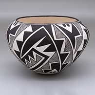 A black-on-white jar with a four-panel Mimbres fine line and geometric design
 by Sarah Garcia of Acoma
