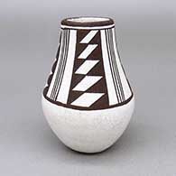 Small black-on-white jar with a four panel geometric design
 by Marie Z Chino of Acoma